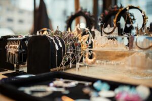 Close-up of exquisite jewelry display including necklaces and crowns, capturing elegance and glamour.