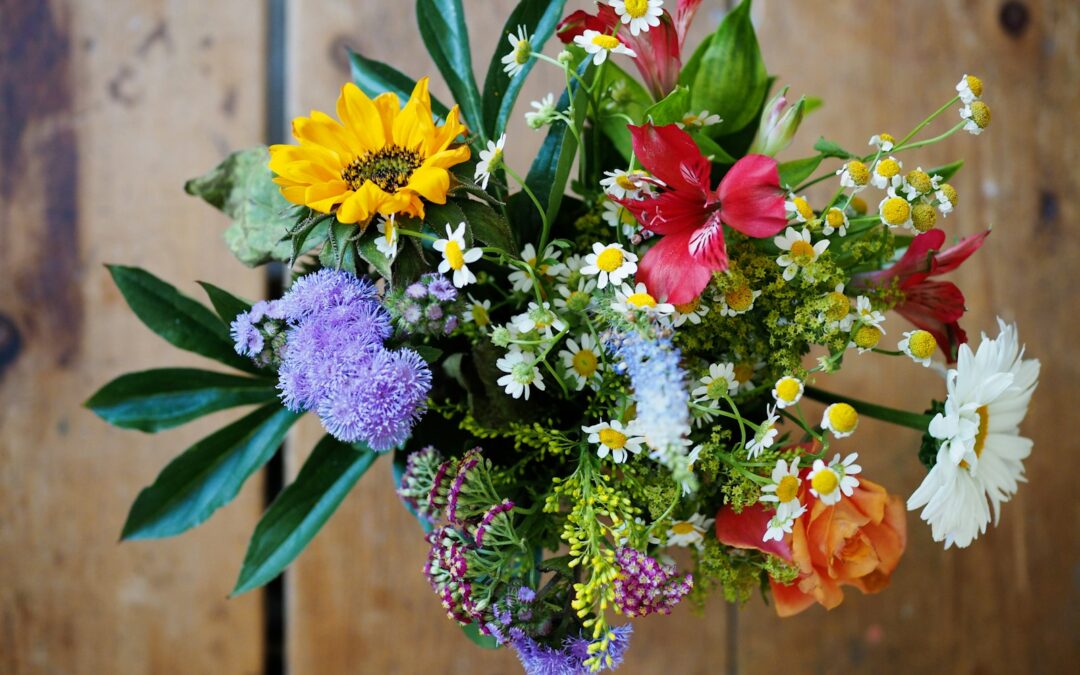 assorted-color flowers on brown wood
